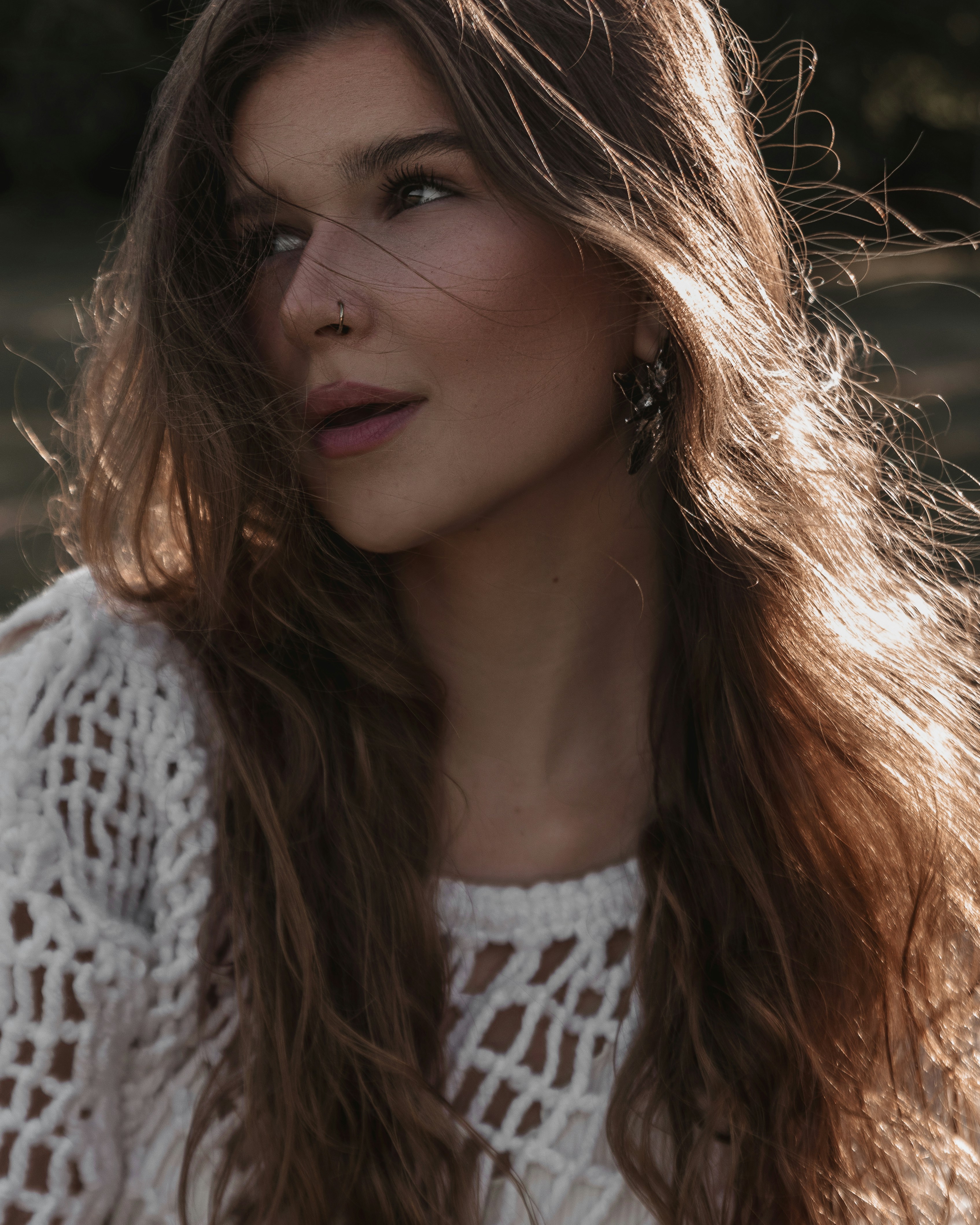 A woman with long hair wearing a white sweater