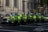 A group of police officers standing in front of a line of motorcycles
