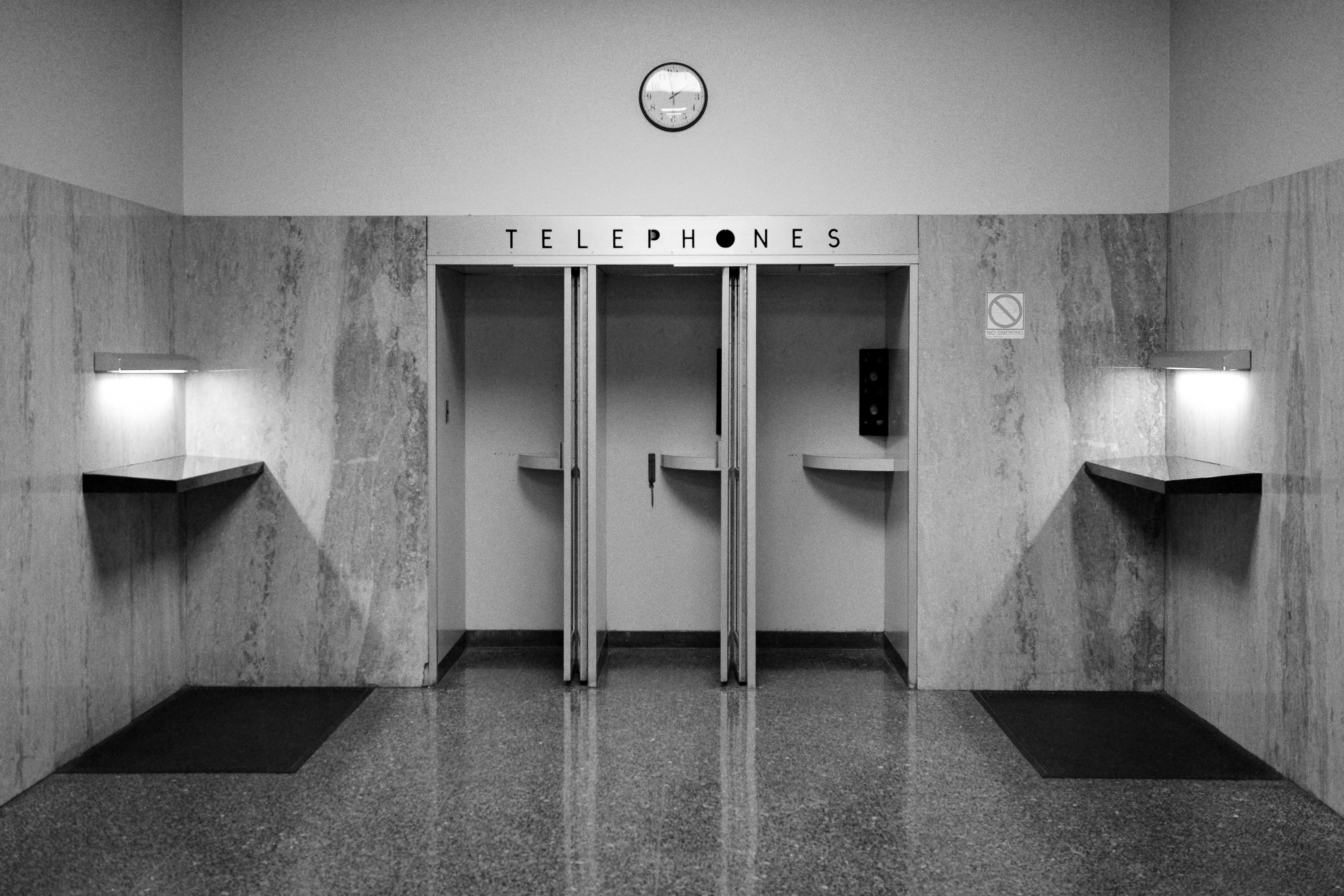 A public restroom with three urinals and three lights