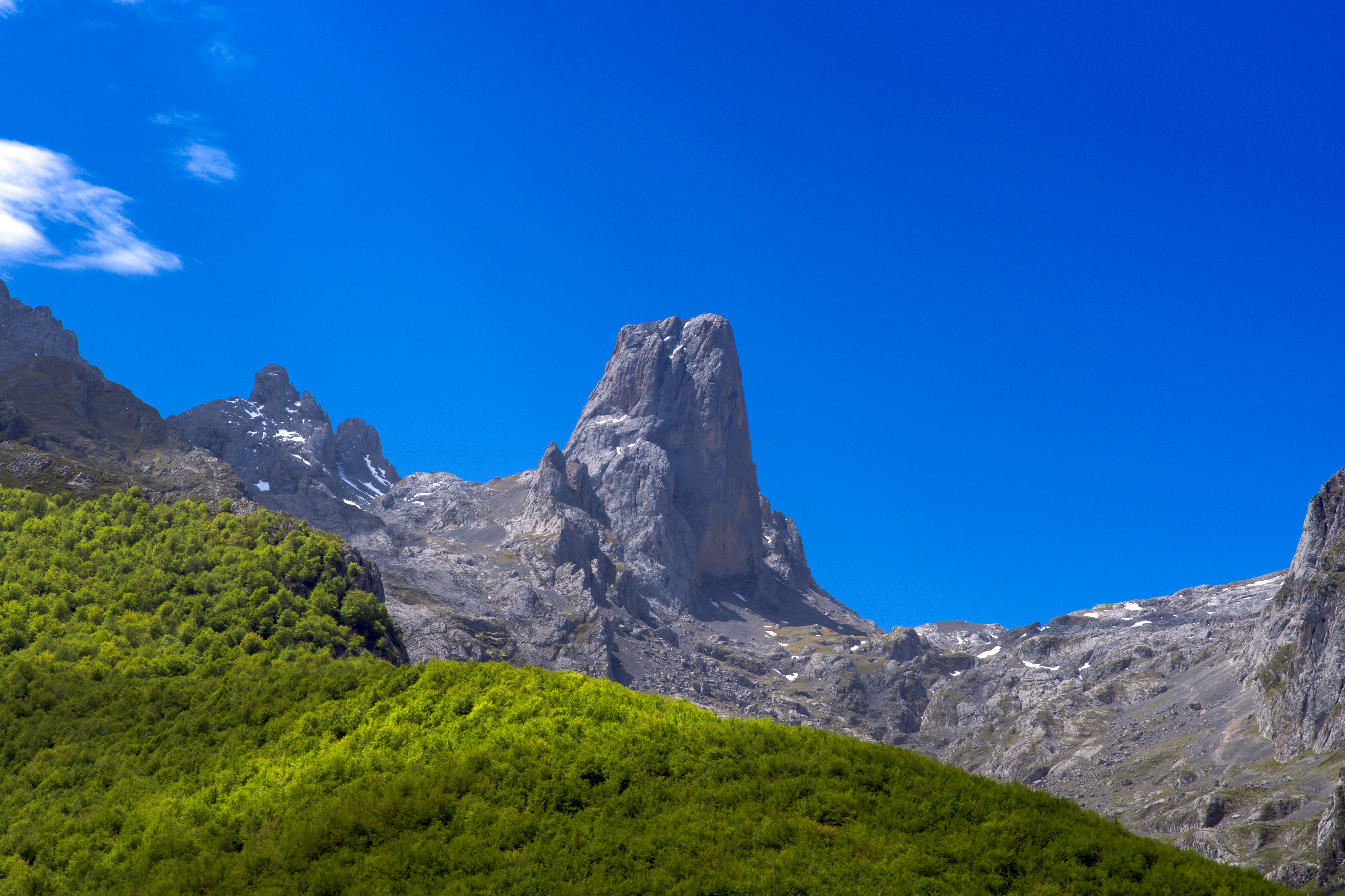 A mountain range with a blue sky in the background, Naranjo de Bulnes