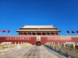 A large building with flags flying in the background