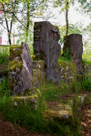 A group of large rocks sitting in the grass