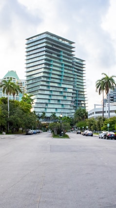 A city street with tall buildings and palm trees