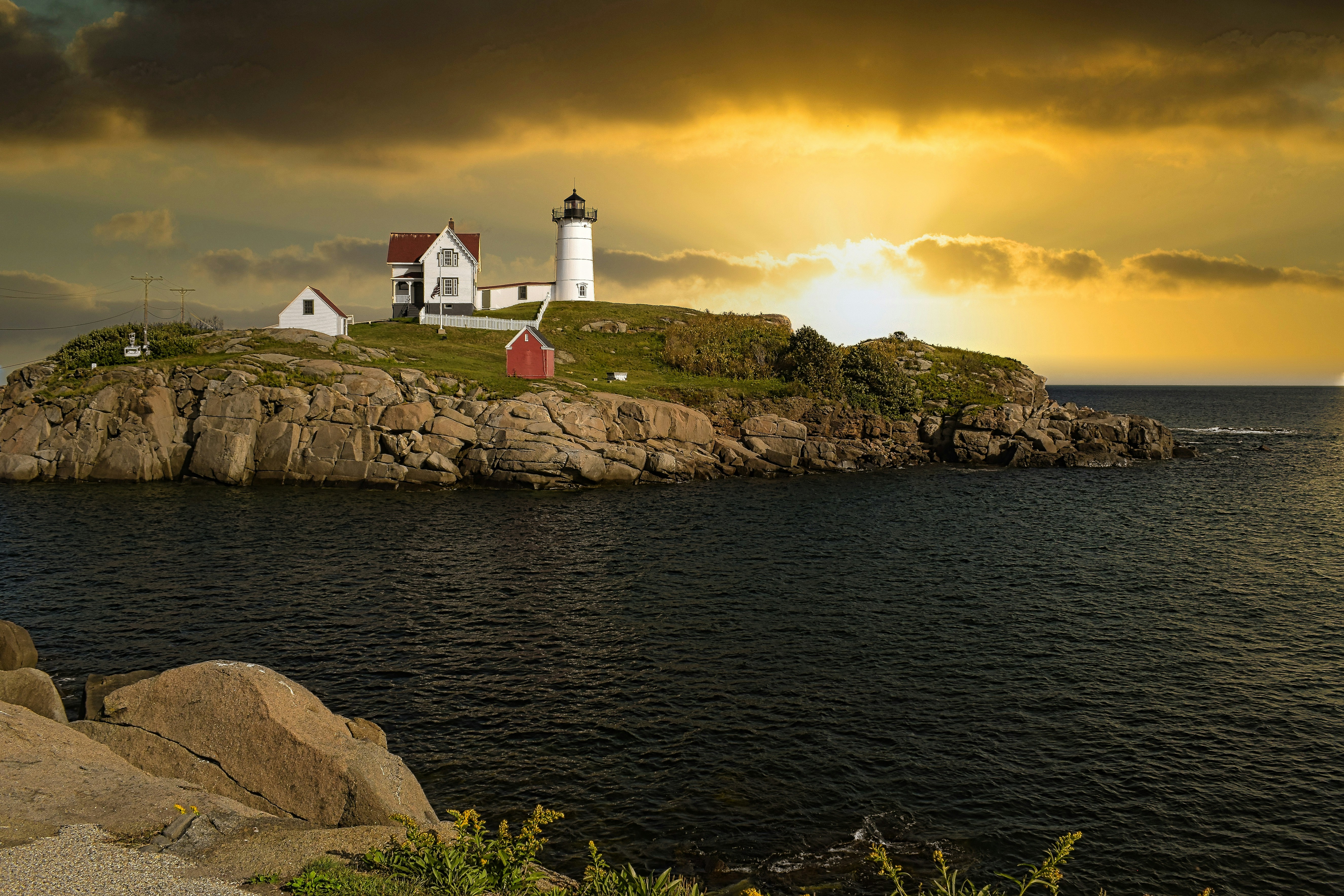 A lighthouse on a small island in the middle of the ocean, Nubbble Light, York, Maine