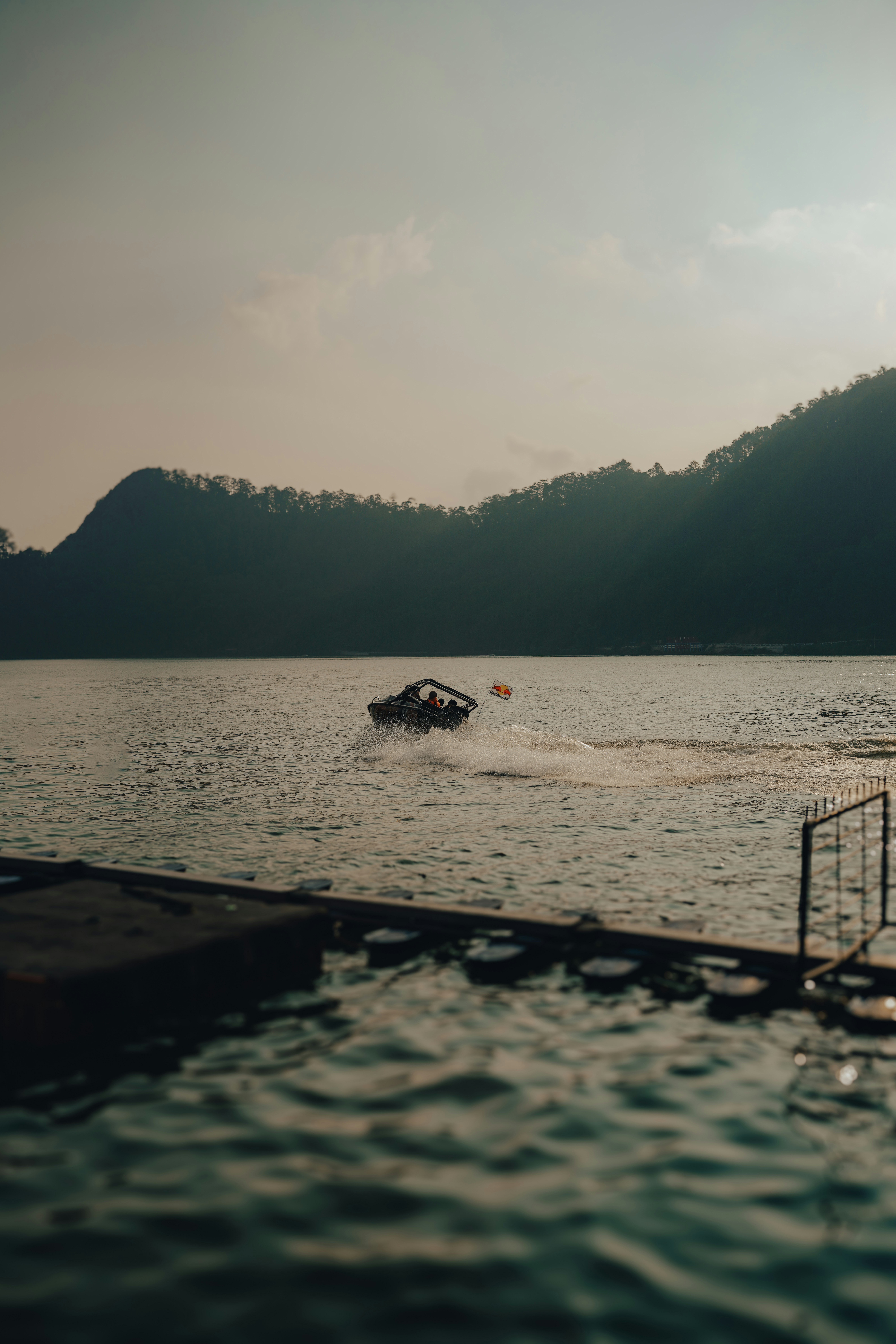 A boat traveling on a body of water near mountains