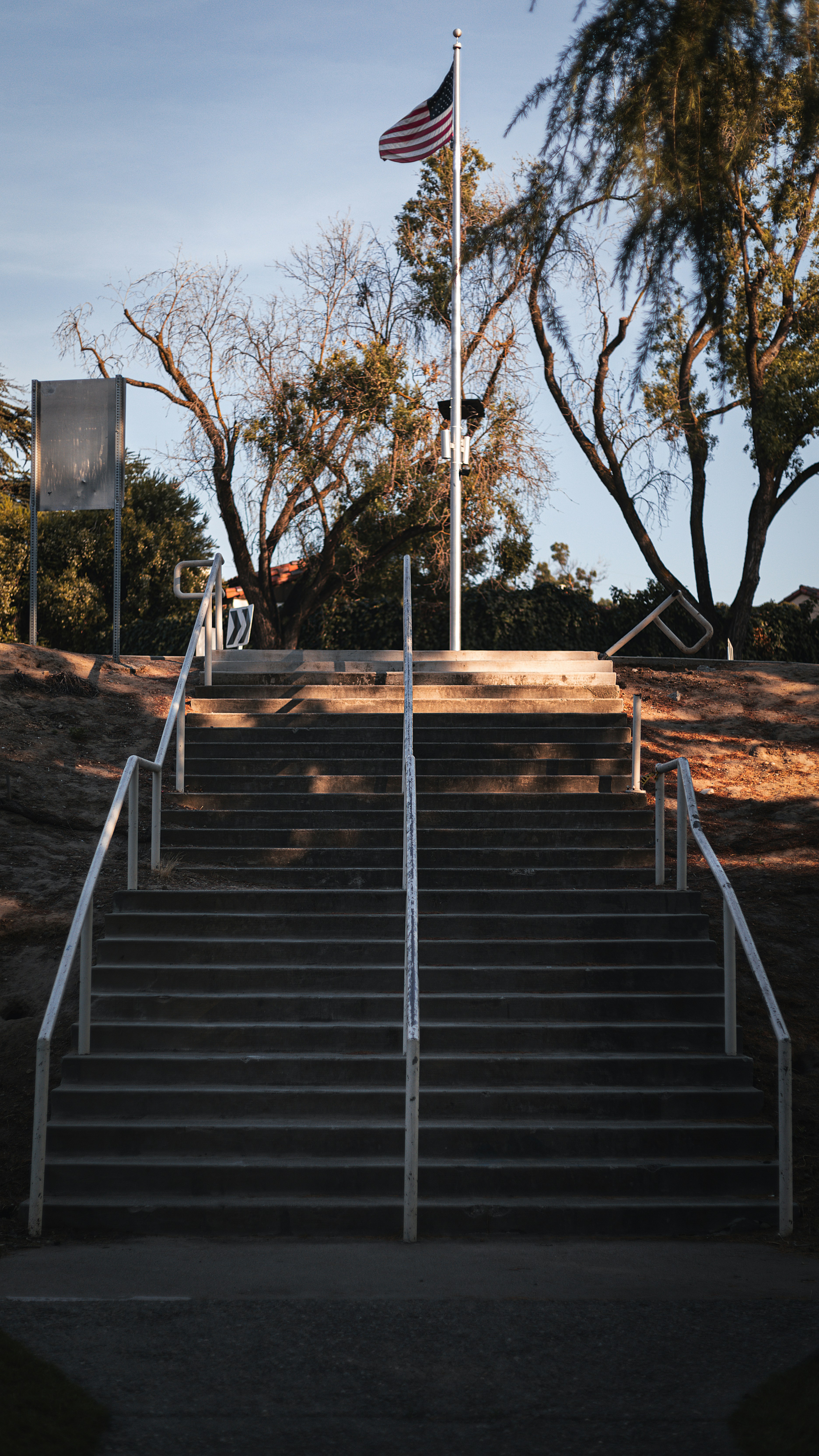 A set of stairs leading up to a flag pole