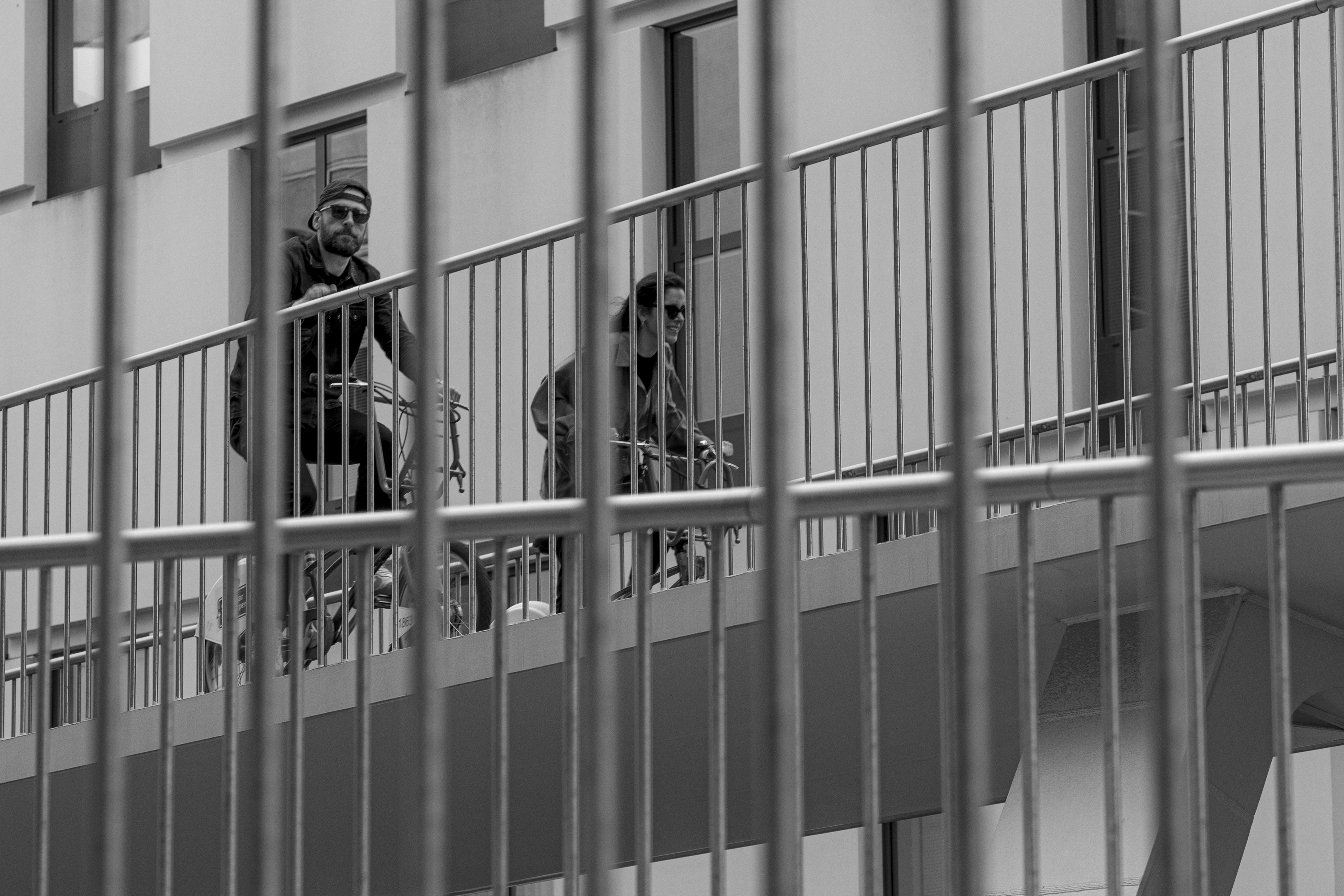 A couple of people riding bikes down a street