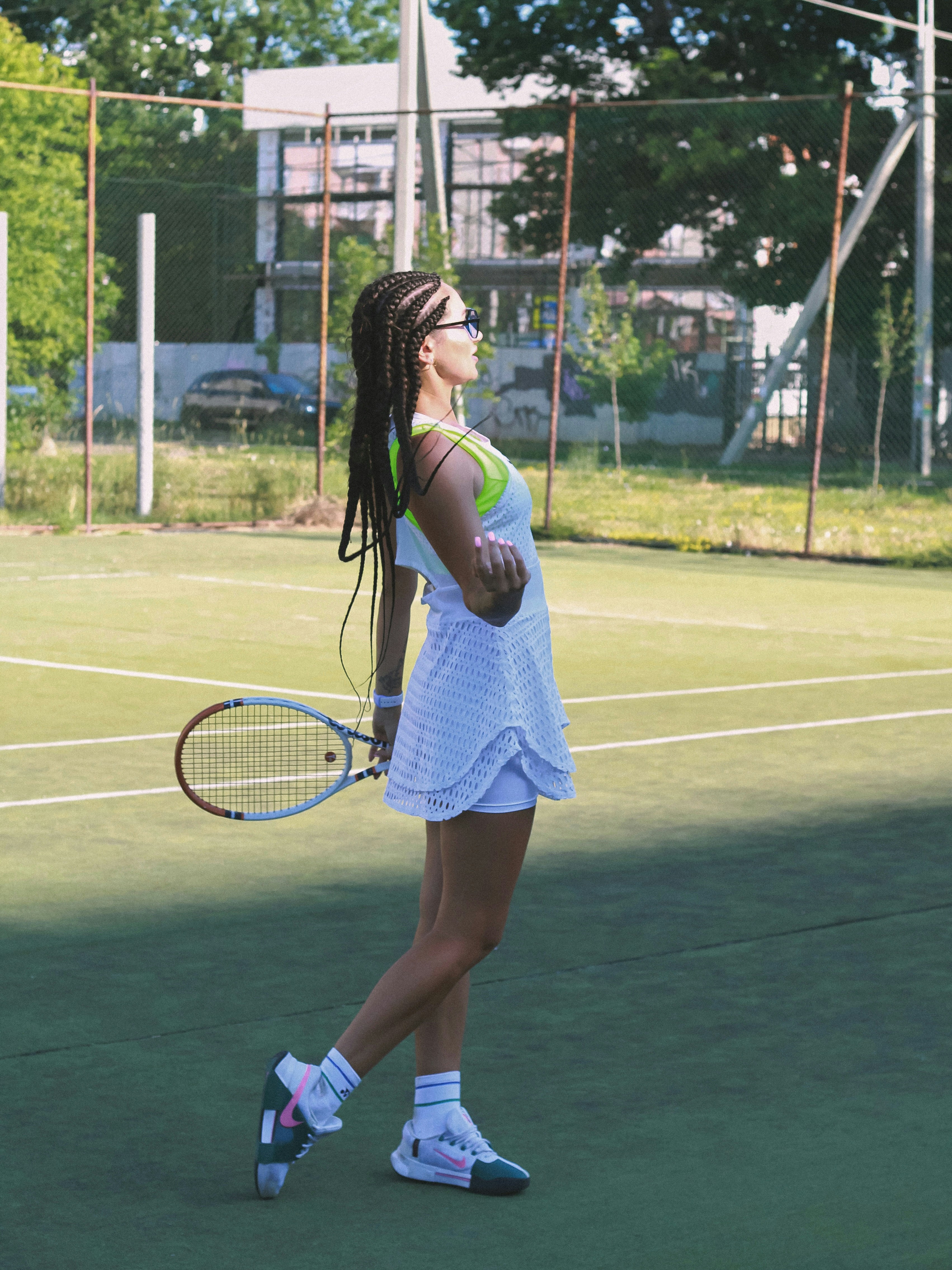 A woman standing on a tennis court holding a racquet