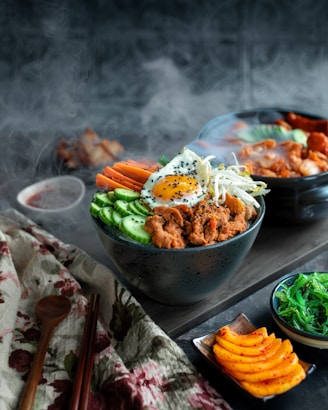 A table topped with bowls of food and chopsticks