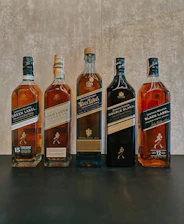 A row of bottles of different types of alcohol