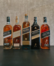 A row of bottles of different types of alcohol