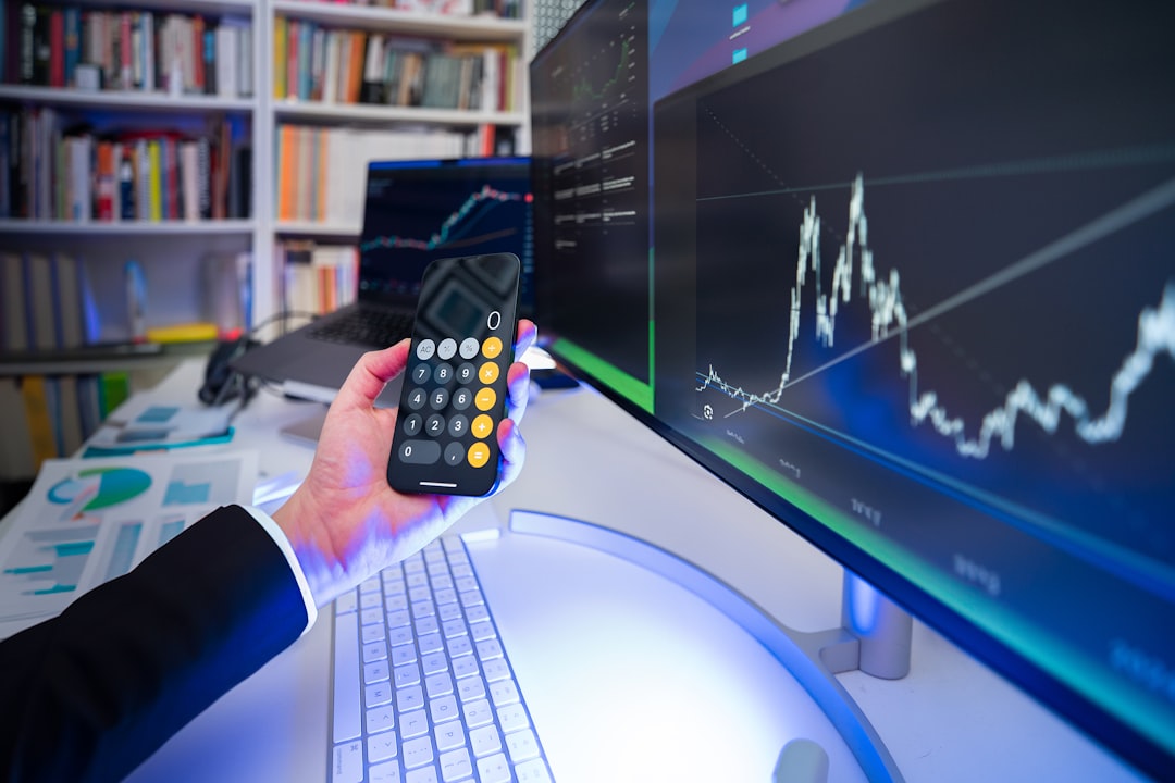 A man holding a remote control in front of a computer, Financial results stock market.