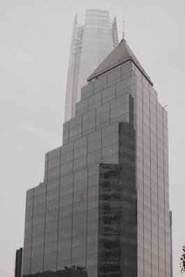 A very tall building with a sky scraper in the background