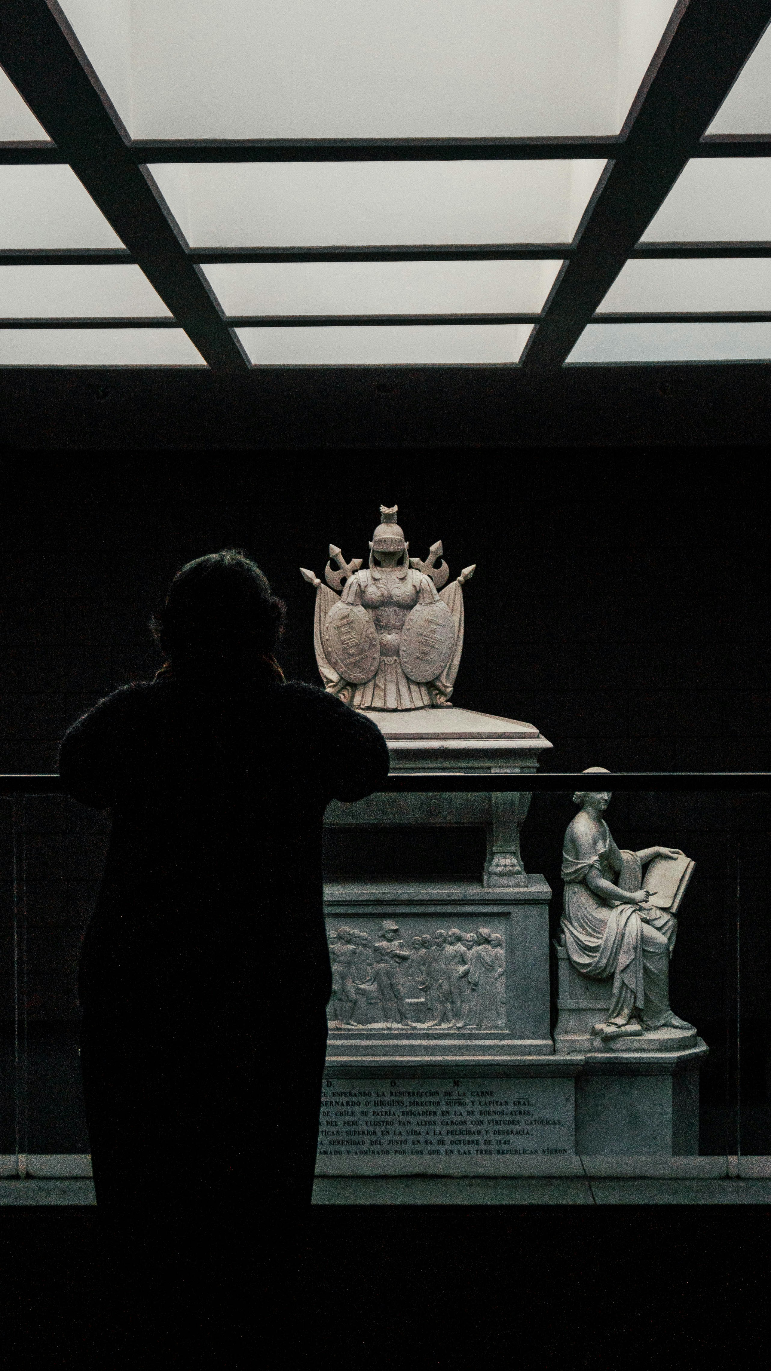 A woman standing in front of a statue
