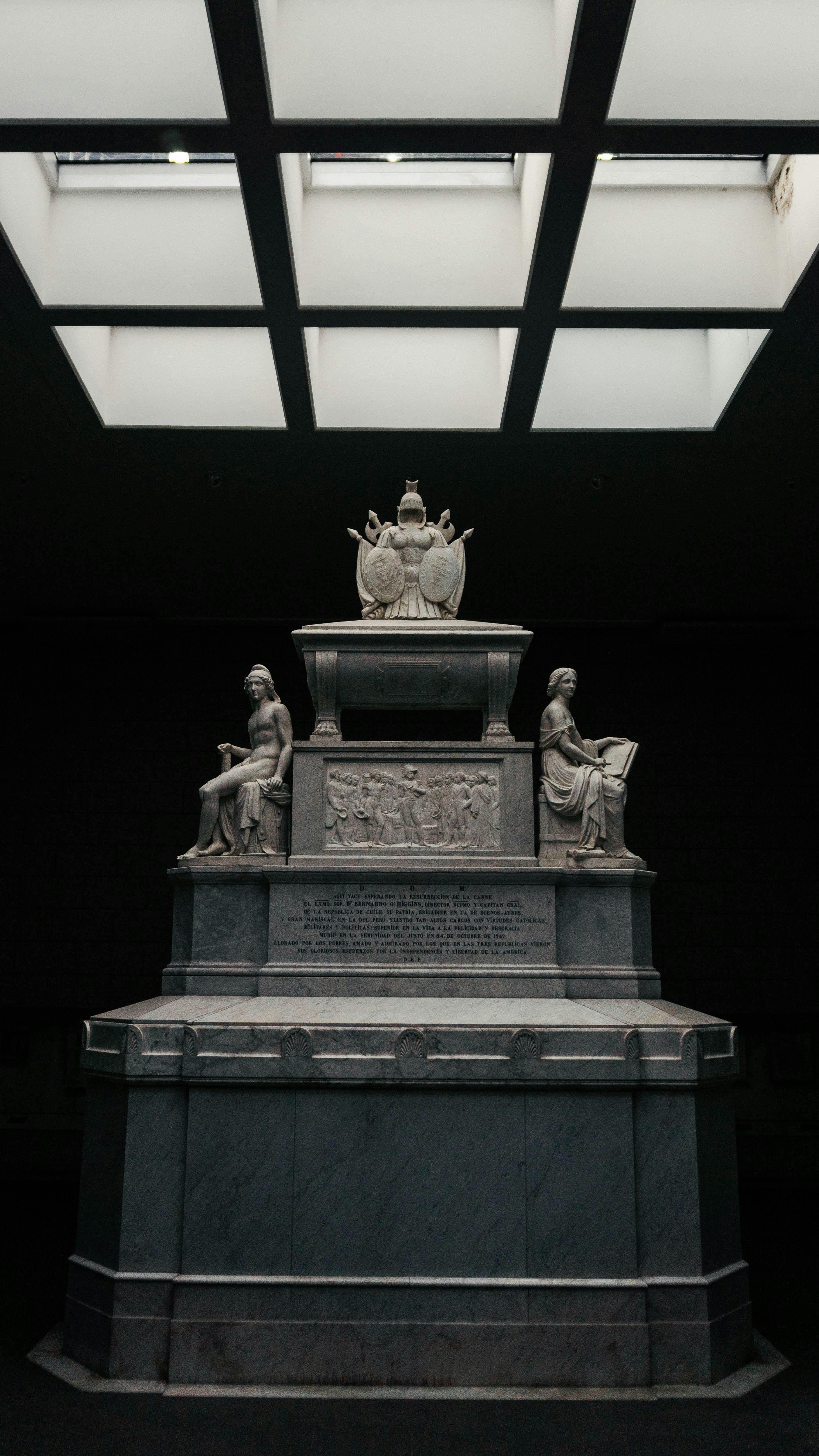 A statue in a room with a skylight above it