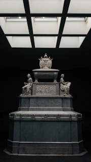 A statue in a room with a skylight above it