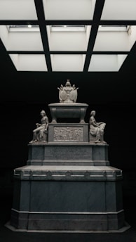 A statue in a room with a skylight above it