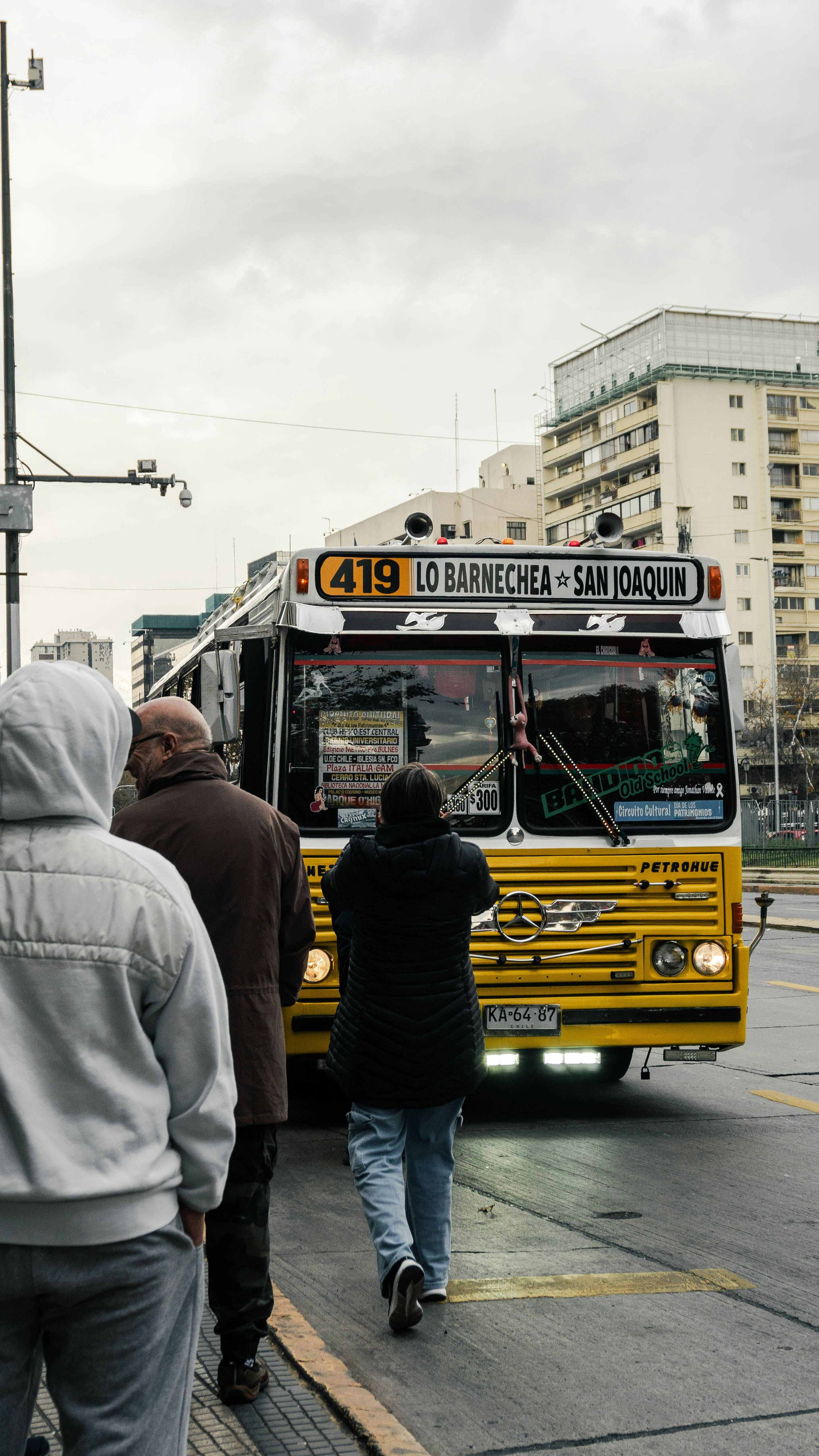 A group of people waiting to get on a bus