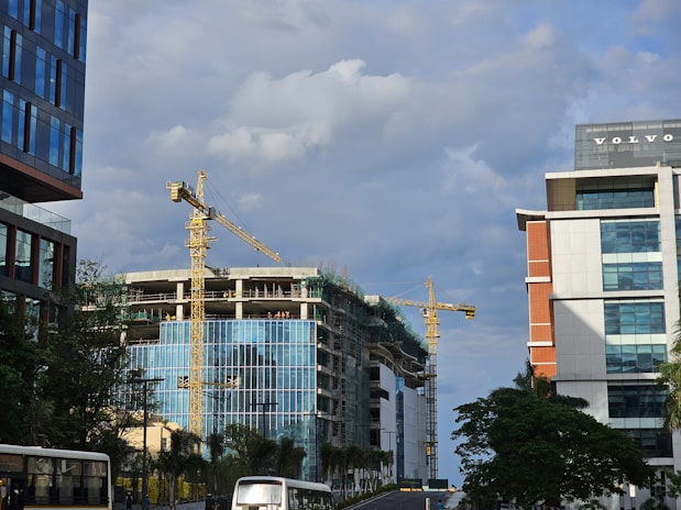A city street filled with traffic next to tall buildings