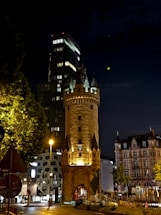 A tall tower sitting next to a street at night