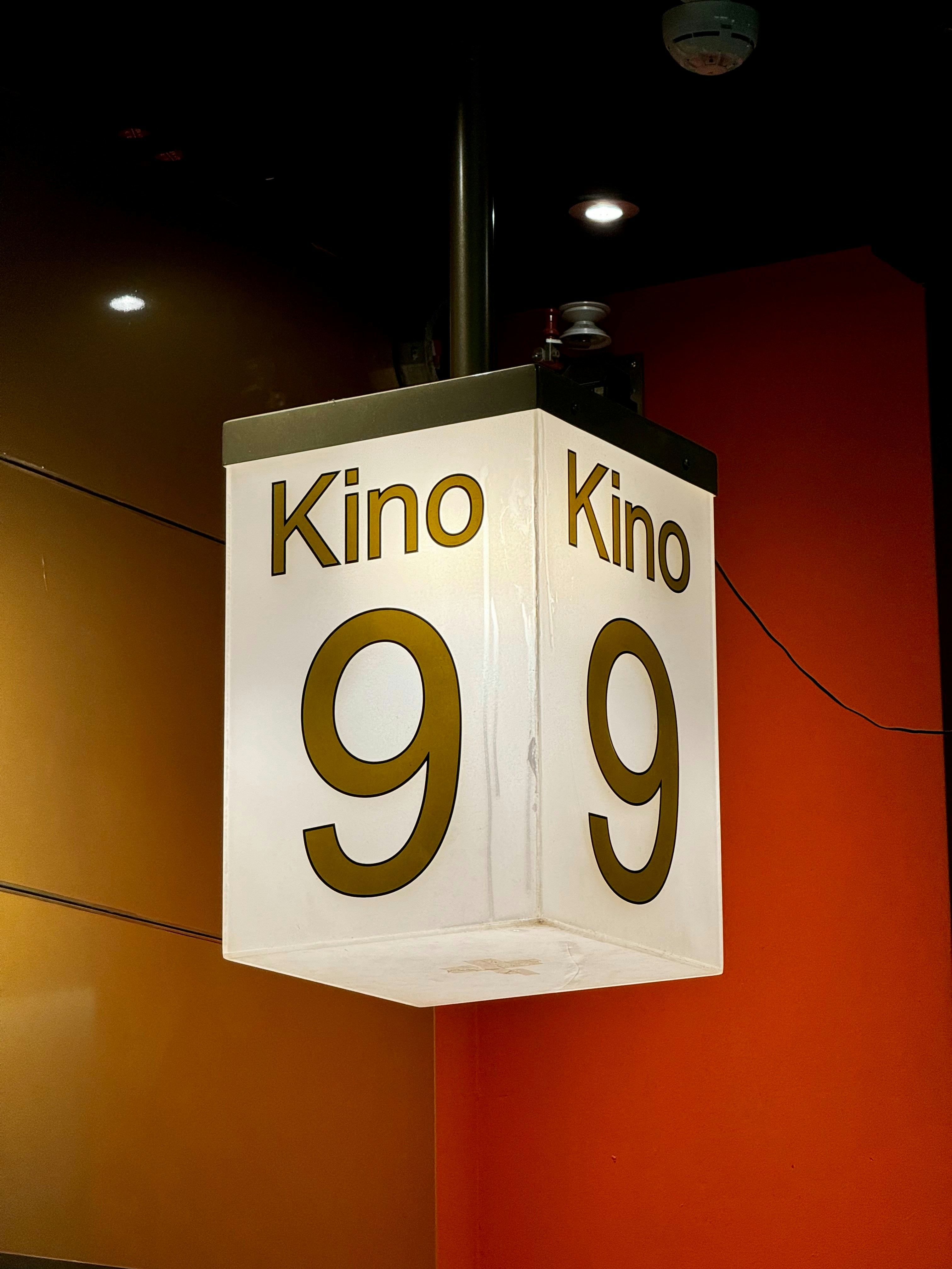 A sign hanging from the side of a building