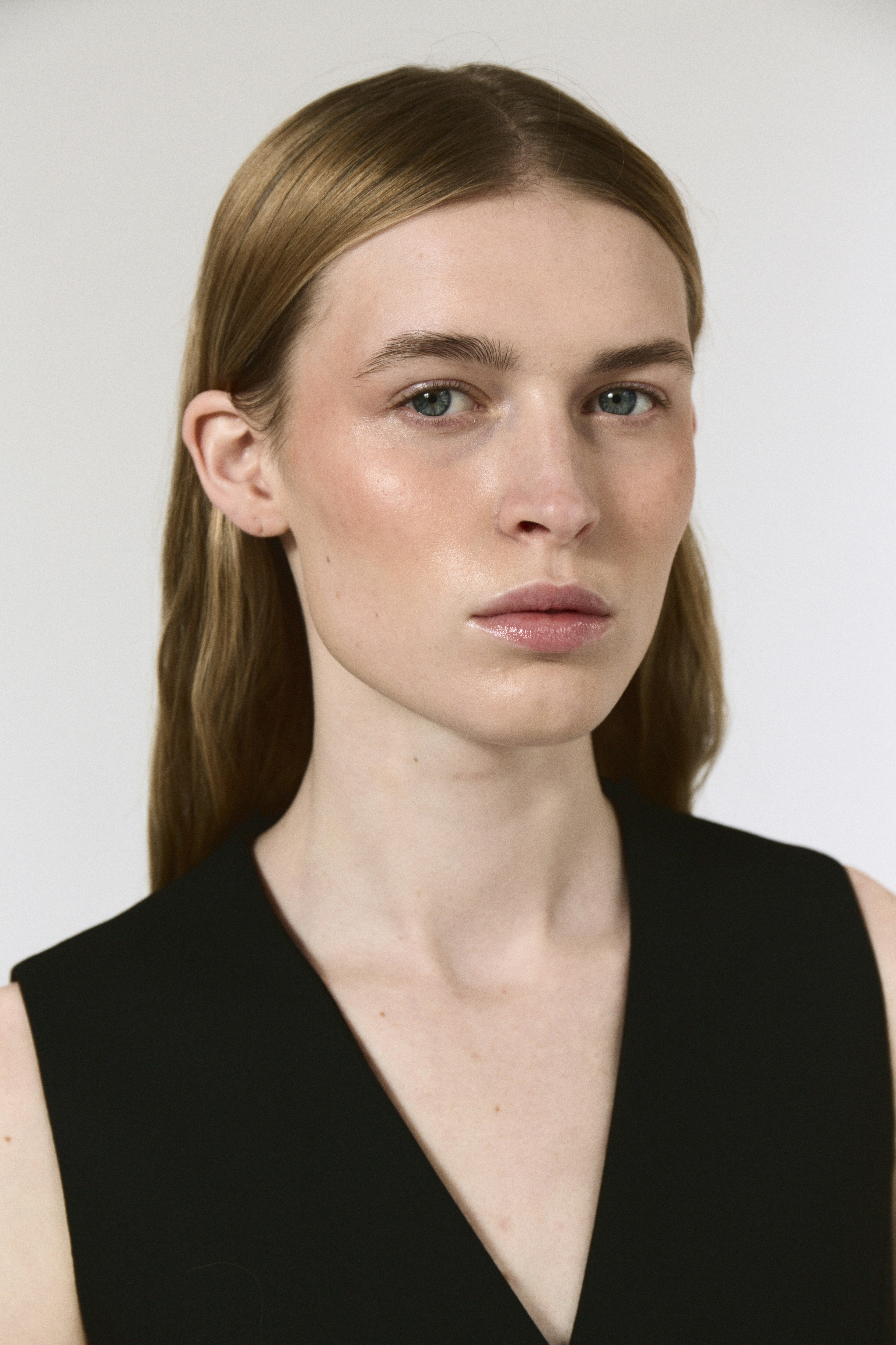 A woman with long hair wearing a black dress