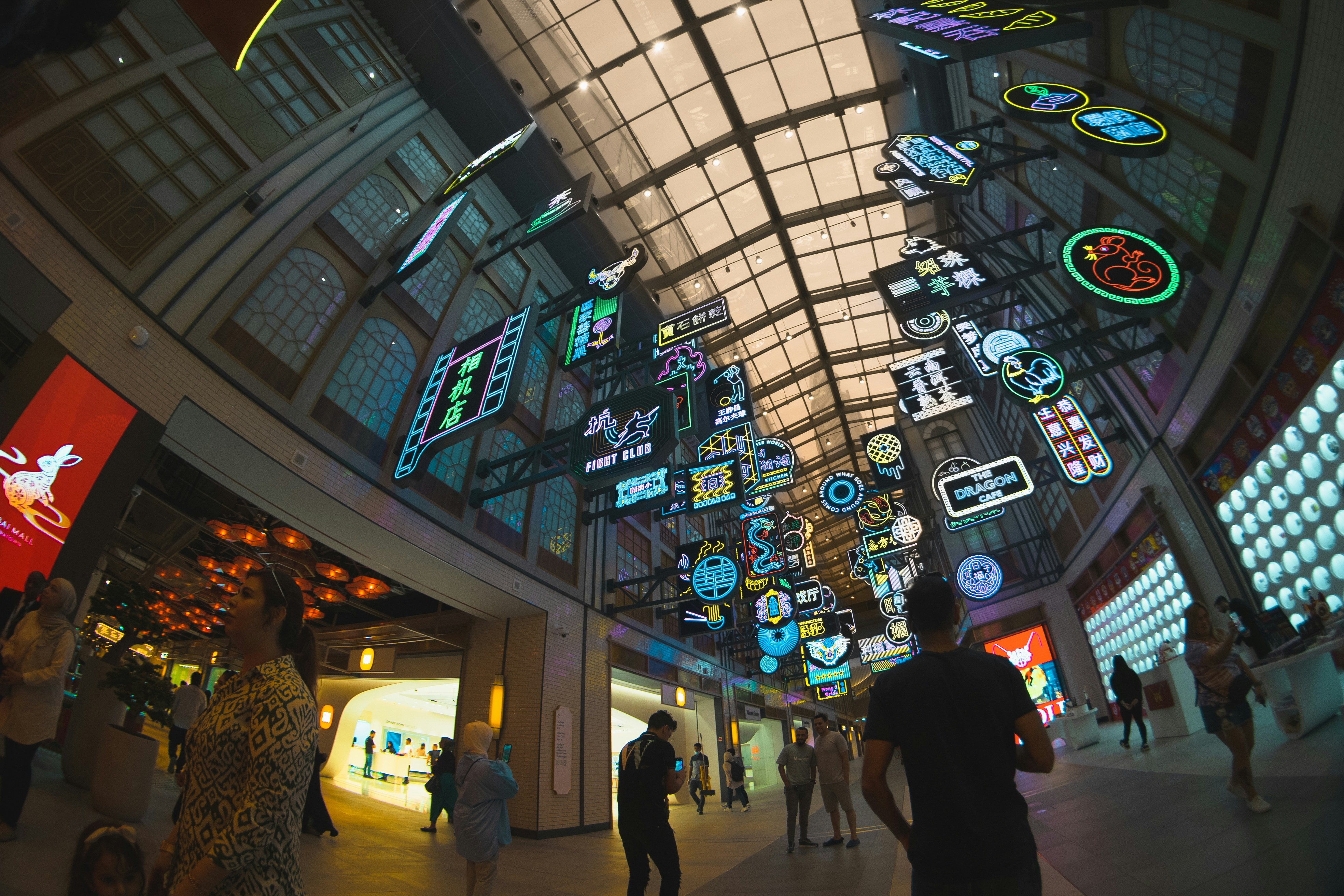 A group of people walking inside of a building
