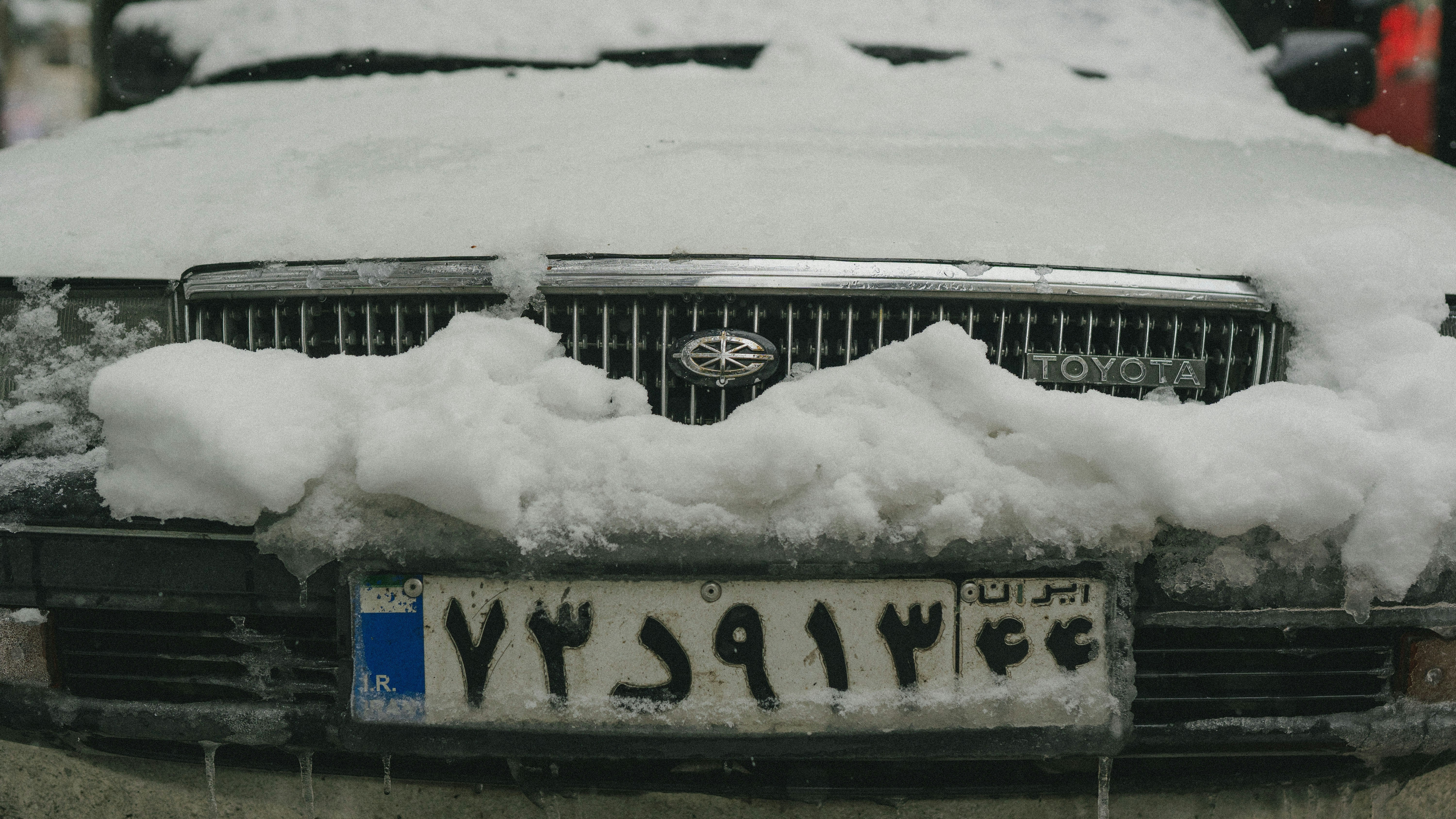 A car covered in snow on a street