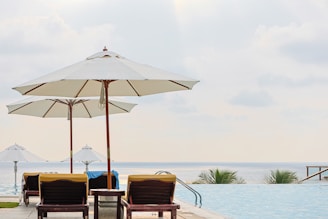 A couple of lawn chairs sitting next to a swimming pool