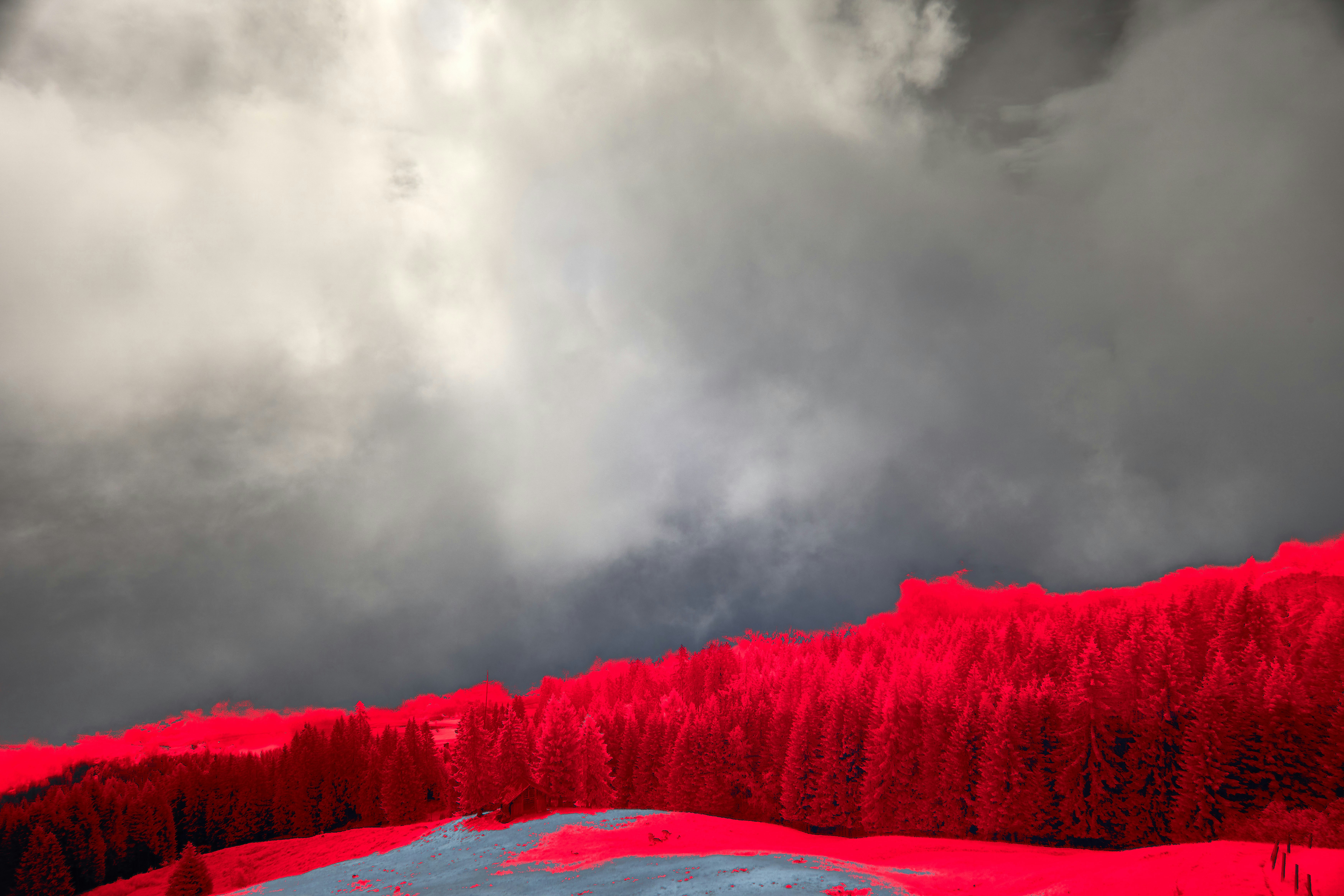A red mountain under a cloudy sky