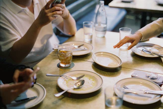 A group of people sitting around a wooden table