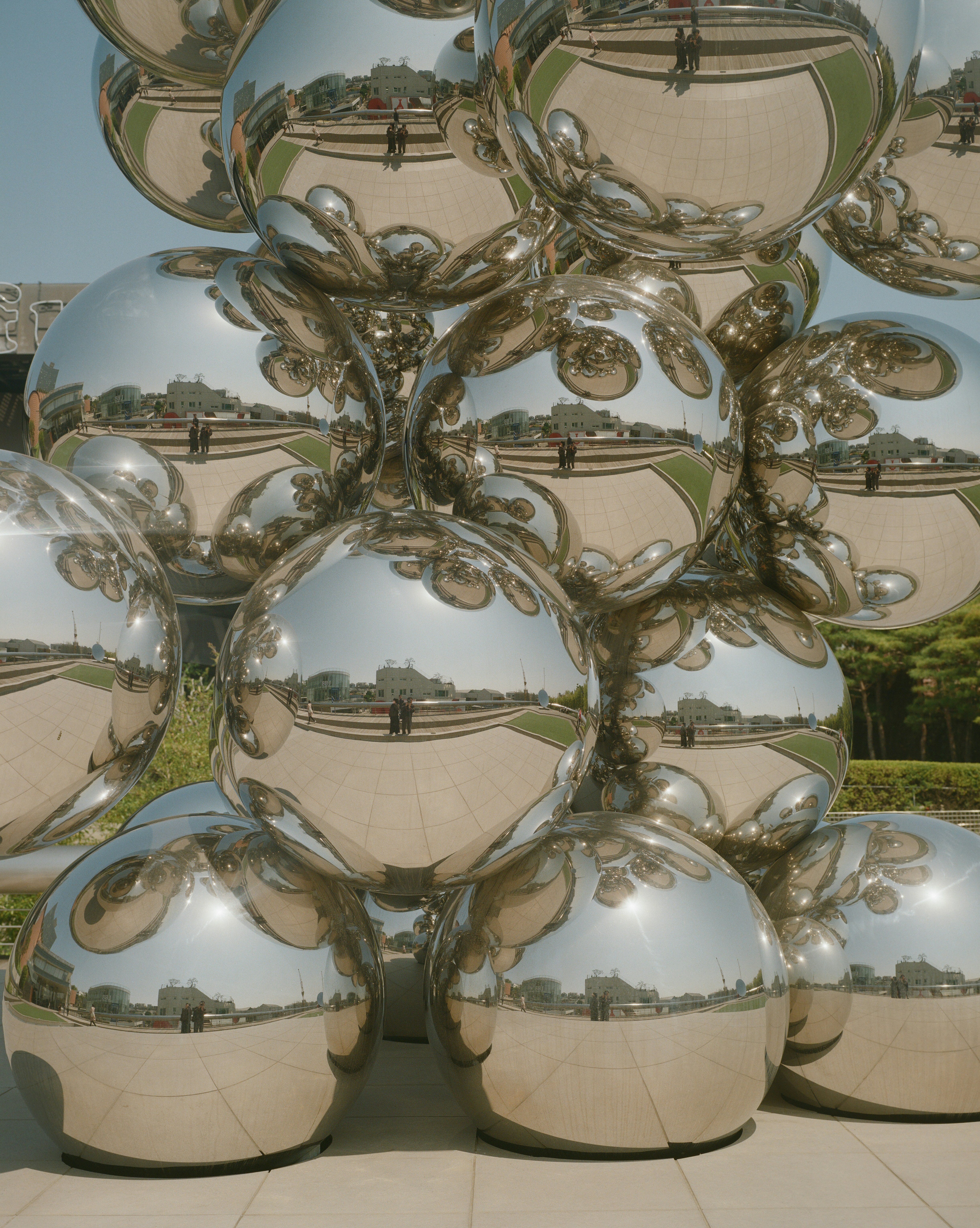 A bunch of shiny balls are stacked on top of each other photo – Free ...