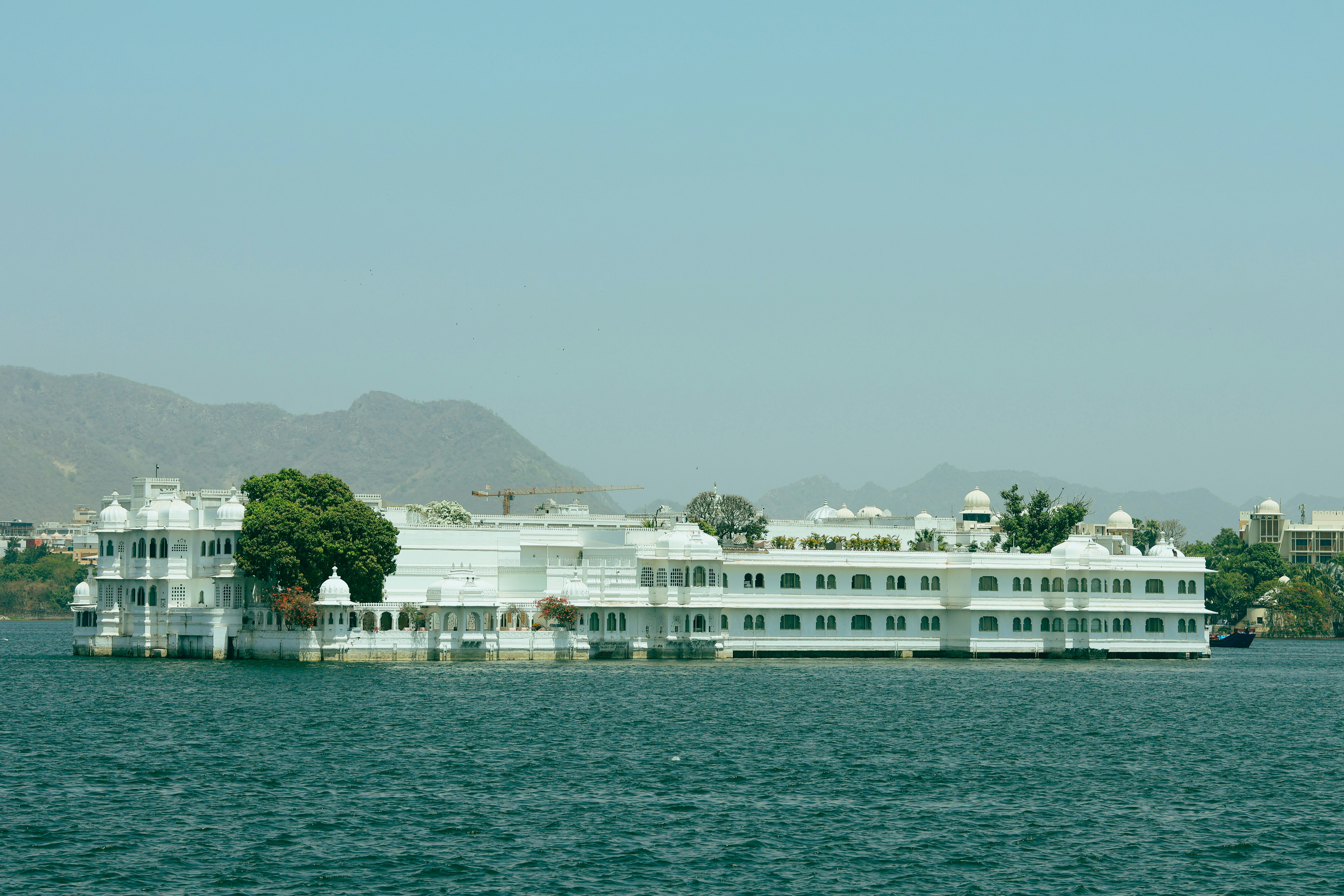 A large white building sitting on top of a lake