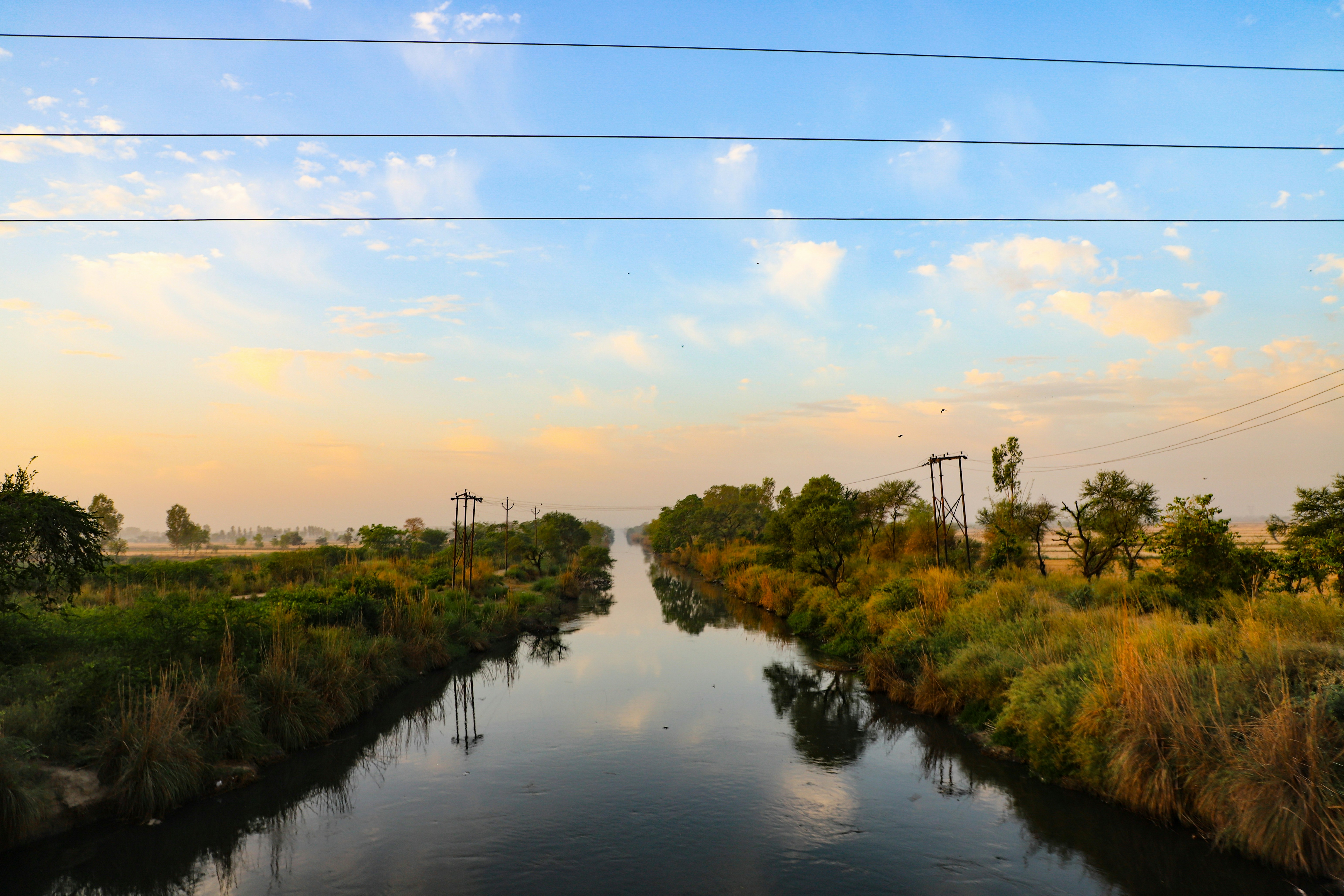 A river running through a lush green countryside