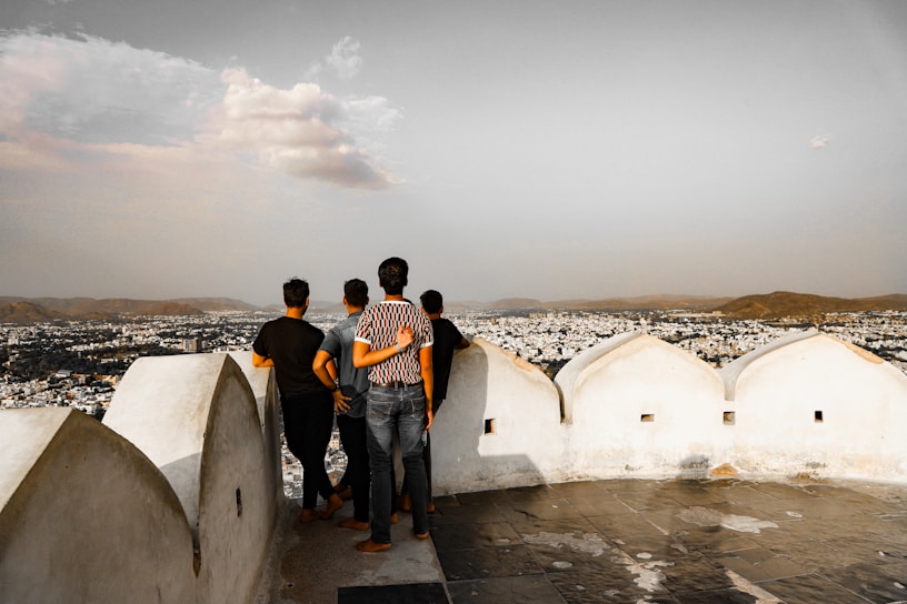 A group of people standing on top of a building
