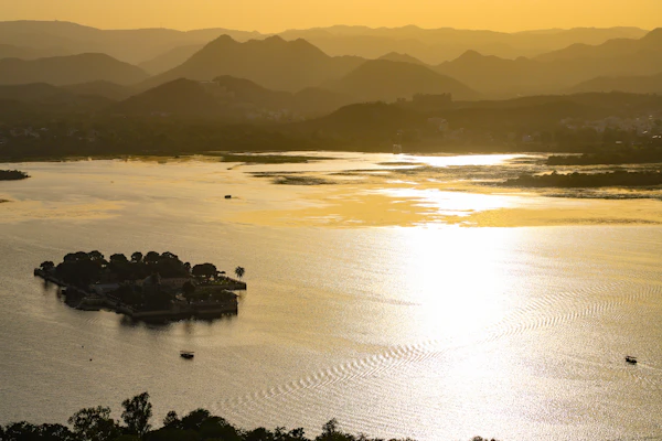 A quiet lake surrounded by the Aravalli hills
