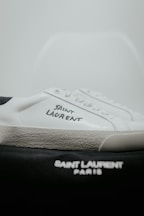 A pair of white and black tennis shoes