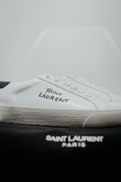 A pair of white and black tennis shoes