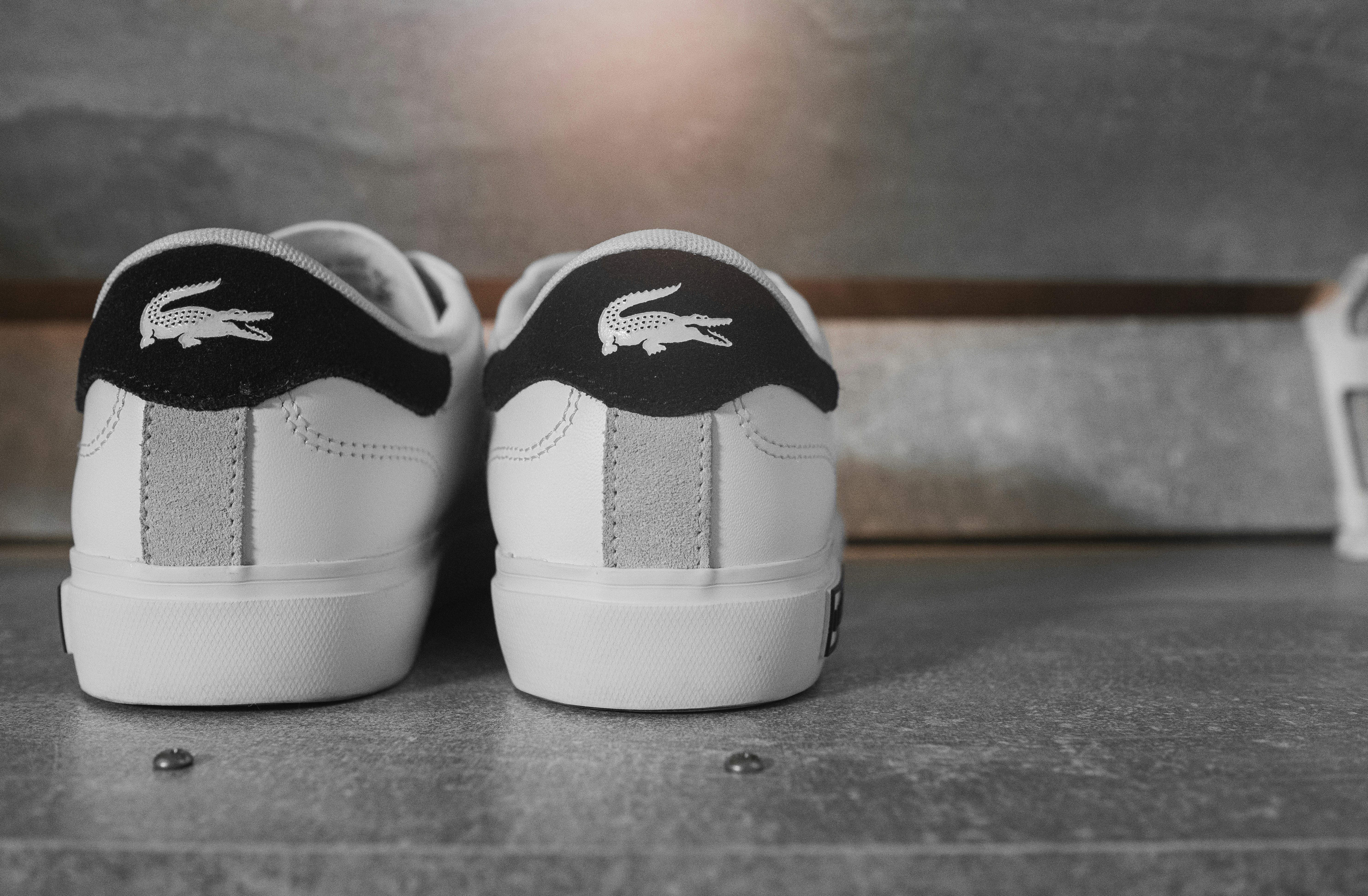 A pair of white and black shoes sitting on top of a bench