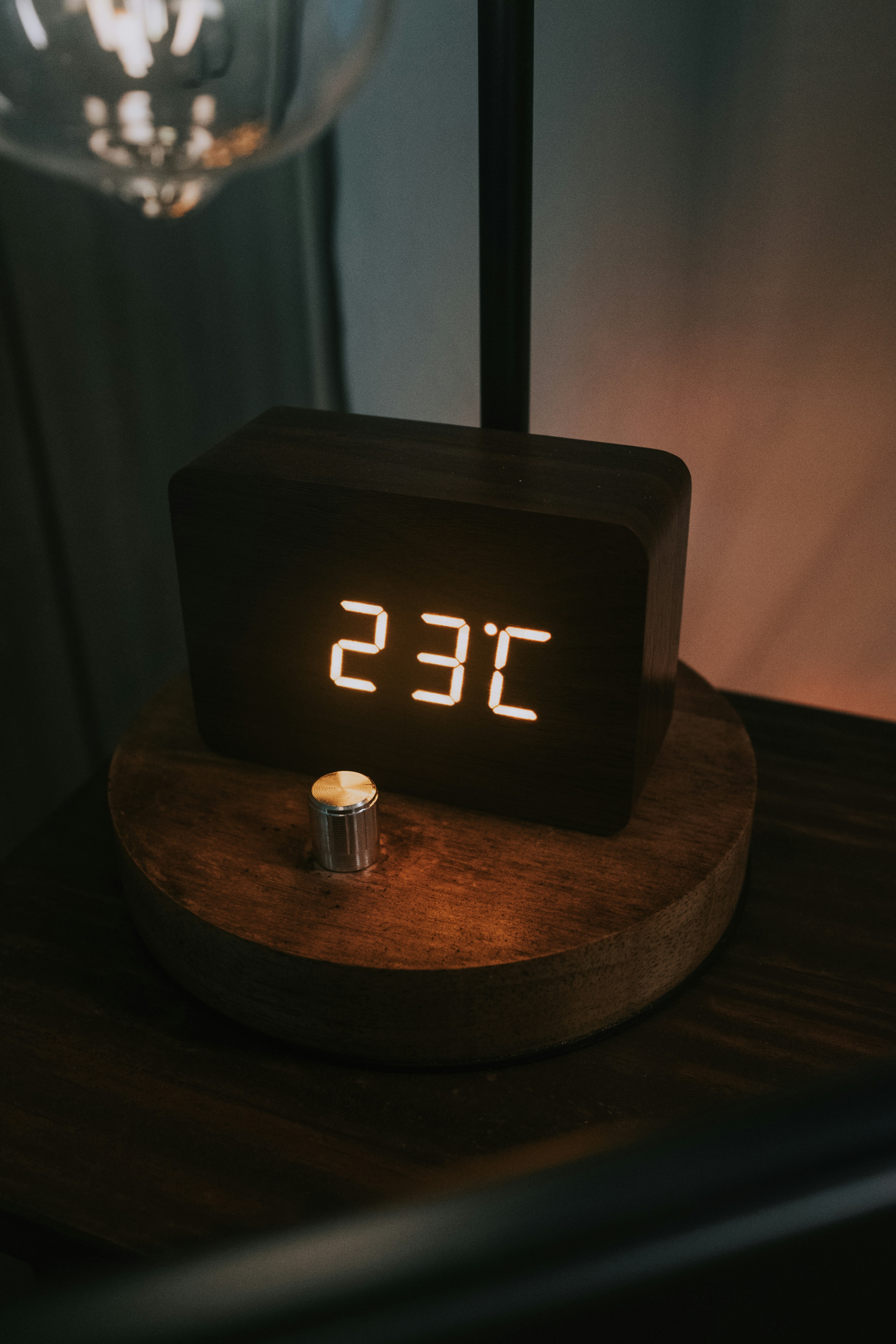 A wooden clock sitting on top of a table