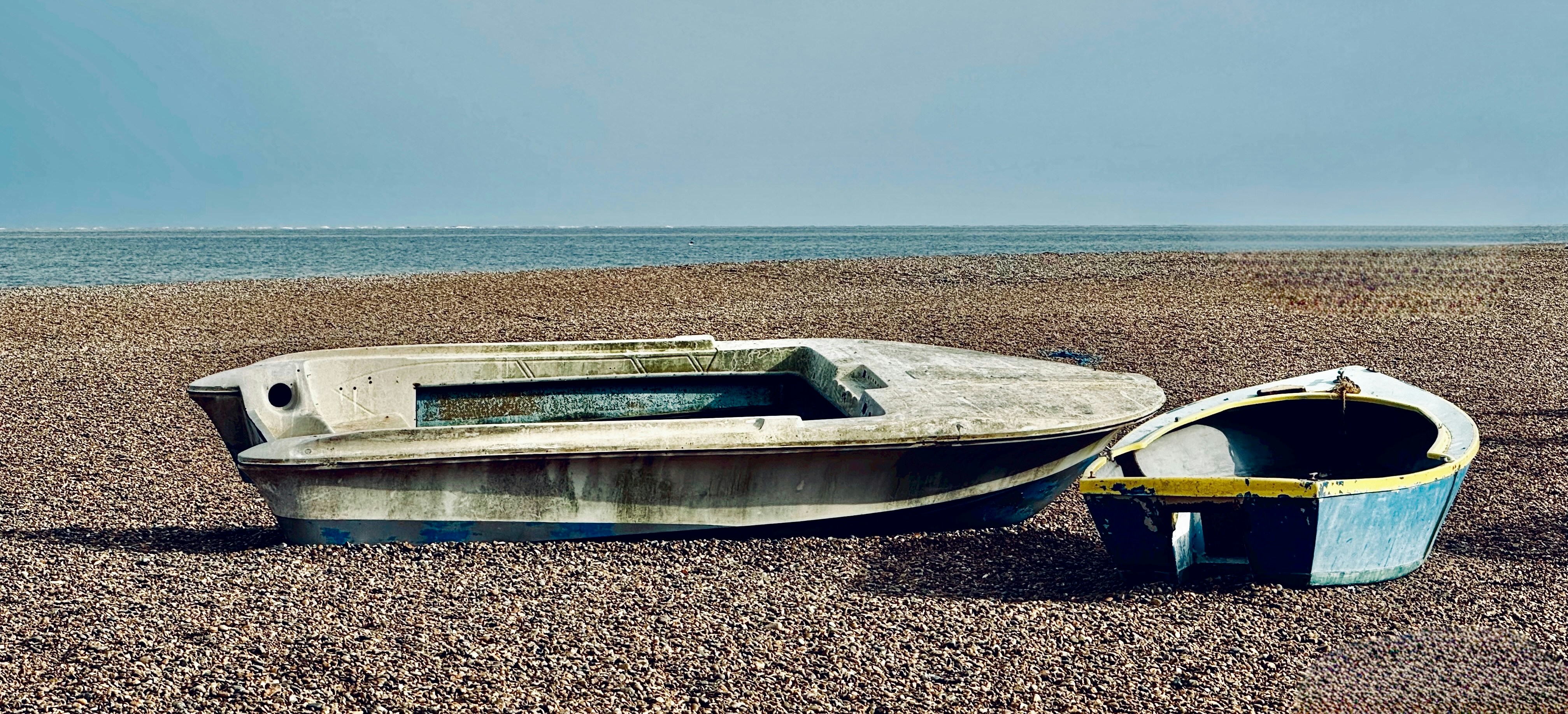 A boat sitting on top of a sandy beach