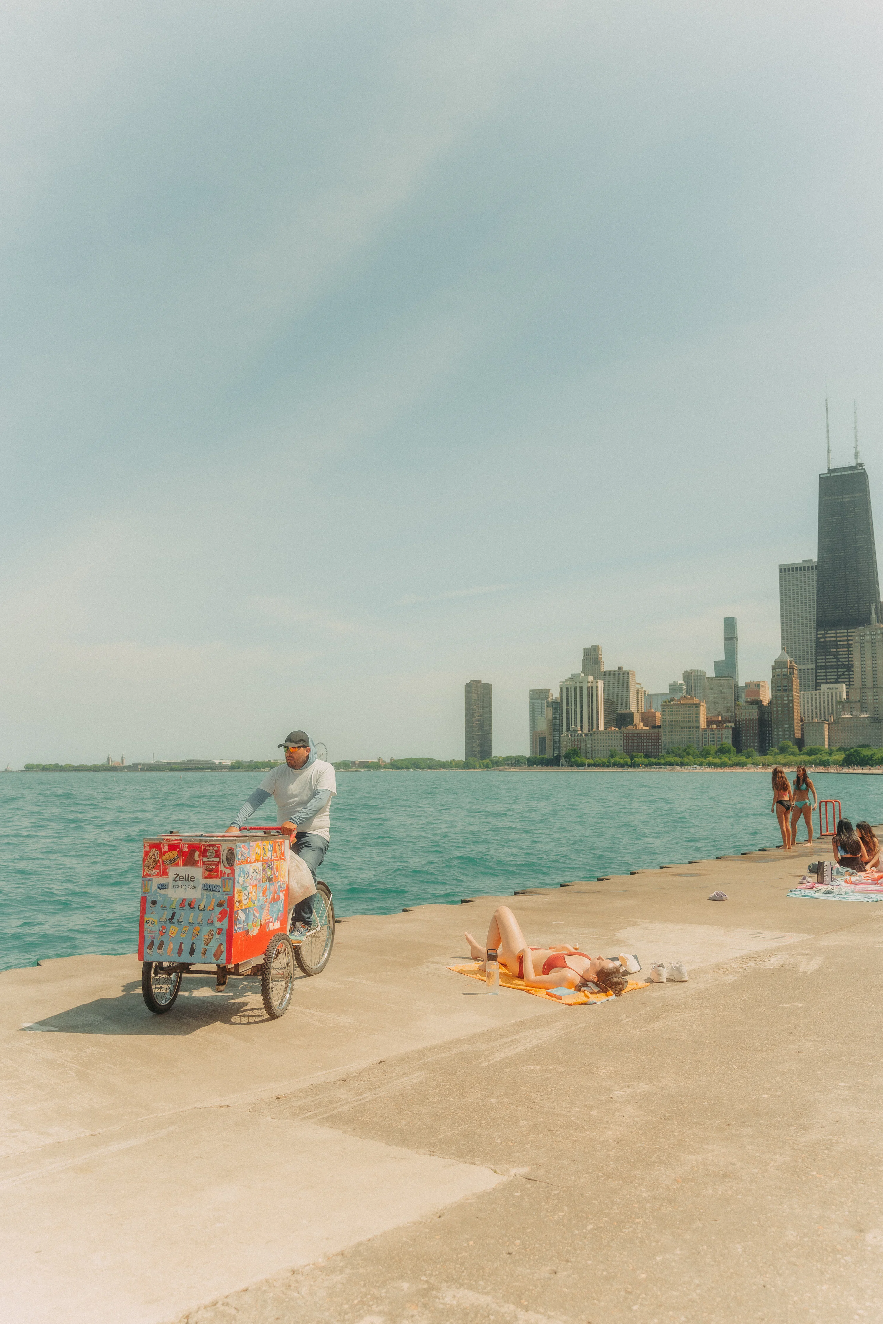 A man riding a bike next to a body of water
