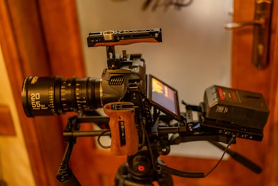 A camera attached to a tripod in front of a mirror