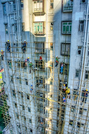 A group of people climbing up the side of a tall building