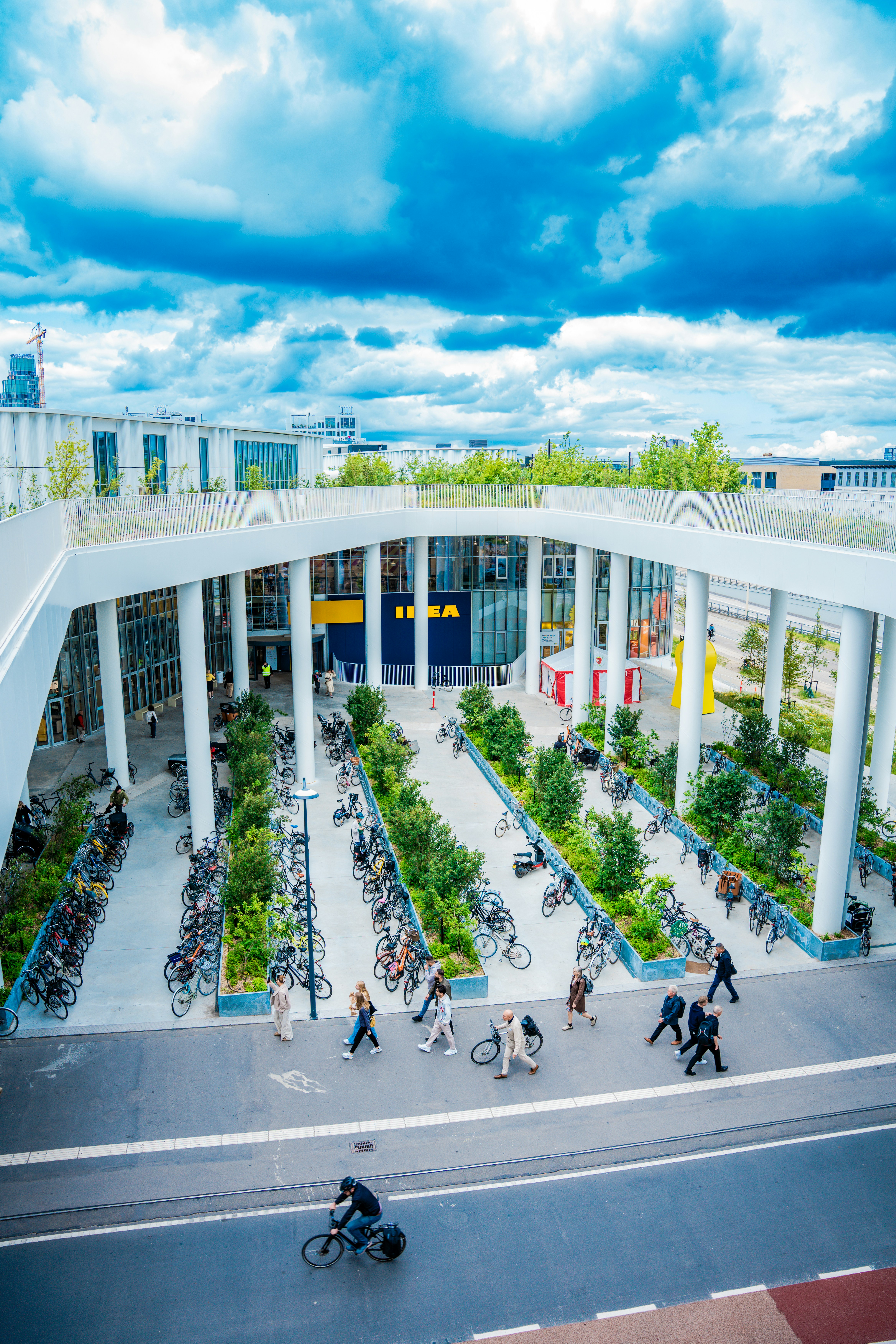 An aerial view of a building with people walking and riding bikes