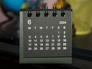 A black and white calendar sitting on top of a table