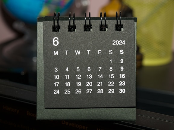 A black and white calendar sitting on top of a table