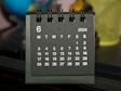A black and white calendar sitting on top of a table