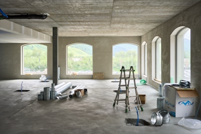 A large room with windows and a ladder
