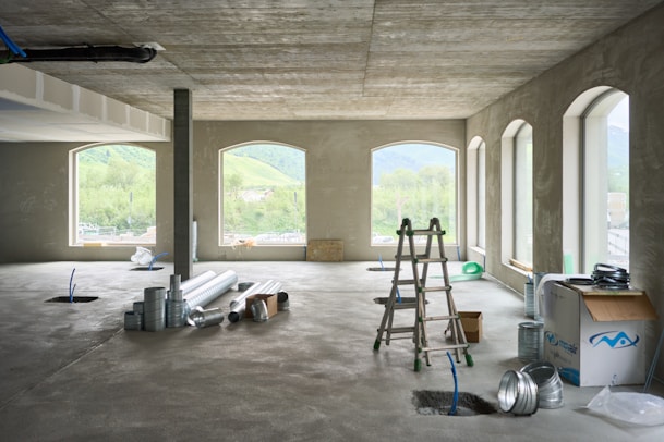 A large room with windows and a ladder
